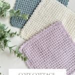 Three Crochet Dishcloths in blue, cream, and lavender are displayed on a light surface beside green leafy stems. Text reads: "Cozy Cottage Crochet Dishcloth Pattern & Video—Quick & Easy.