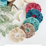 Five crochet scrunchies in vibrant colors are displayed beside a star-shaped candle, yarn skeins, and green foliage on a white surface. Text reads "Caribbean Seashore Crochet Scrunchie.