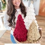 Woman holding a basket with three Loopy Crochet Trees in red, white, and beige; text reads "Bulky & Quick Loopy Trees Crochet Pattern & Video.
