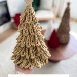 A hand holds a crocheted loopy tree with a star on top; two more Loopy Crochet Trees sit on a table in the background. Text below reads "BULKY & QUICK LOOPY TREES Crochet Pattern & Video.