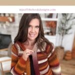 Woman wearing a striped, autumn-colored Suzette Raglan crochet cardigan, standing indoors with a cozy, decorated background. Text above reads "The Suzette Raglan Cardigan Crochet Pattern & Video.