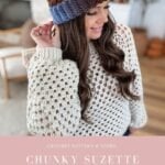 Woman wearing a crocheted sweater and a chunky, multicolored Chunky Suzette Stitch Beanie with a pom-pom, standing indoors. Text promotes a crochet pattern for the Suzette Stitch Beanie.