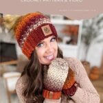 A woman wearing crocheted fingerless gloves and mittens in autumn colors sits indoors, smiling and showing off the cozy accessories. Text above reads "Chunky Suzette Stitch Mittens Crochet Pattern & Video.