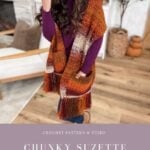A woman wearing a chunky pocket shawl in suzette stitch and autumn colors sits on a chair in a cozy living room. Text reads: "Chunky Suzette Stitch Pocket Shawl" with website link.
