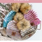 Four colorful crochet beanies with faux fur pom-poms arranged on a tray, featuring the Winterberry Beanie. Text reads "Winter Crochet Beanie," "Free Crochet Pattern," and "Easy Accessory Pattern.