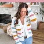 Woman wearing a striped crochet cardigan stands in a cozy living room. Text reads "Spring Crochet Cardigan Pattern," featuring a reversible crochet pattern—perfect as a handmade wardrobe essential.
