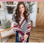 A woman models a white, red, and black geometric mosaic crochet poncho pattern. Text overlay reads “Cozy Inset Mosaic Crochet Poncho Pattern” and “Mosaic Poncho Fall Layer.”